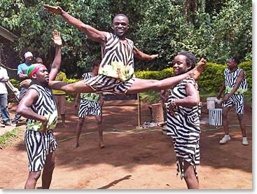 The team celebrating their climb with acrobatic entertainment