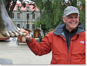 For generations there has bee a tradition that explorers should kiss the feet of the native for good luck before departing for the wilds. Bob Melville is seen here with the well polished bronze toes of the Patagonian native man.