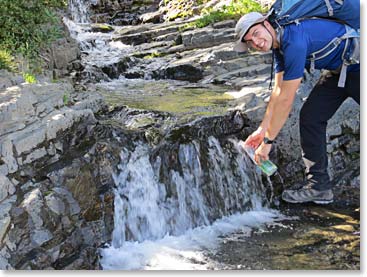 Ren refilling the water bottle along the trail