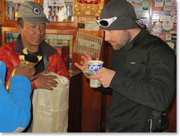 Steve prepares to sip his Chang. Chang is local Sherpa alcohol drink and it is an important part of ceremonies to Sherpas.