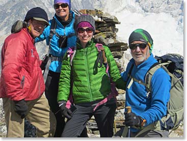 Below the highest winds our trekking team poses at a Buddhist chorten on the side of the mountain.