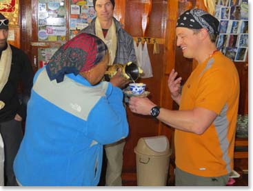 Daniel receives his chang from Lakpa Doma.