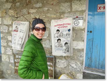 Katie Ross admired the educational drawings about health, child care and sanitation posted outside the clinic.  Many of the patients are illiterate.  