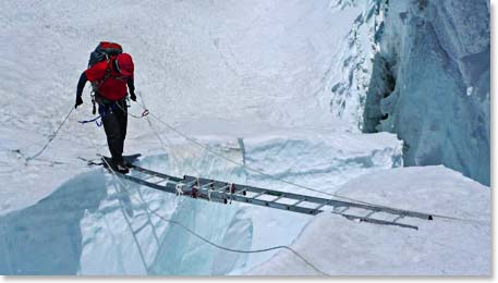 Image of climber crossing a deep crevasse below Camp II