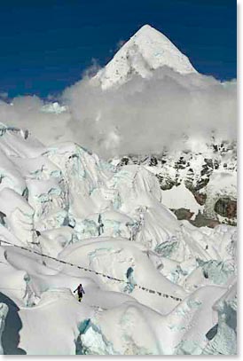 Climbers make their way down the upper Icefall