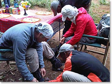 Guides helping climbers gear up with their gaiters