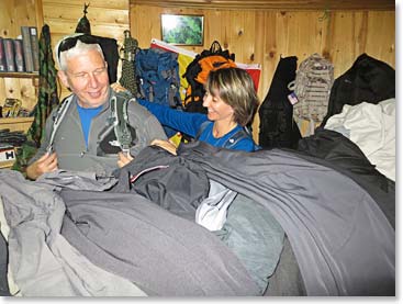 Margaret helps Tim try on a new pack to check for fit.