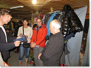 Vladimir and the shop owner discuss the qualities of a pair of gloves.