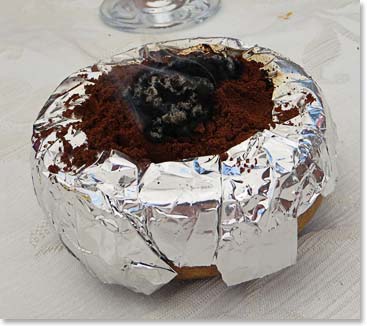 A pot with Turkish coffee is brought to the table and lit to avoid bees.
