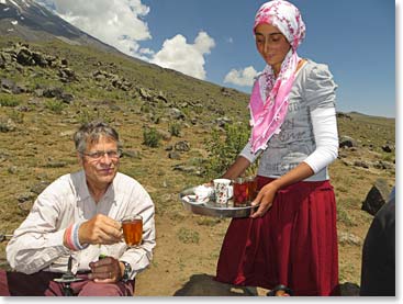 Evert Broekers trying some local tea served by a shepherd girl 