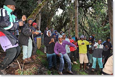 The Berg Adventures crew always finds time for singing and dancing; here they make the most of their time at the Umbwe Camp.