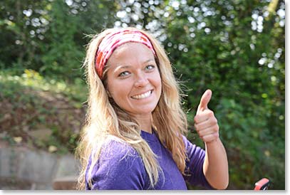 At the trailhead, with the vehicles waiting to take us back to Arusha, Autumn gives her thumbs up for a great trip.