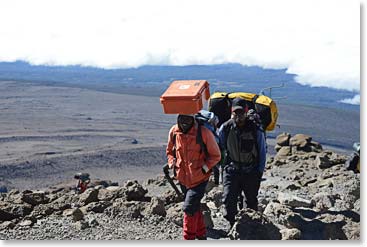 Arnold and Andrew on the way to the summit.  Arnold always carries our medical box – even to the very top of Kili!