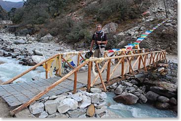 Scot walks on a bridge across the Imja Khola river, on the way to Pangboche