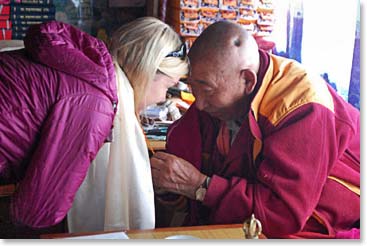 Lama Geshe offers blessing to Keely.