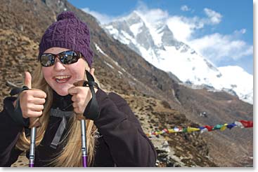 Alyssa posing for a photo with another famous peak, Lhotse, in the background.