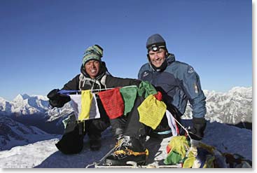 Sandu displays the prayer flags which they left in thanks for a safe and successful climb to over 6000 meters.