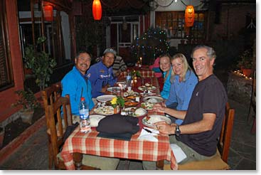 The Sellers family, Ang Temba, and Min sit down for a nice dinner in Pokhara.