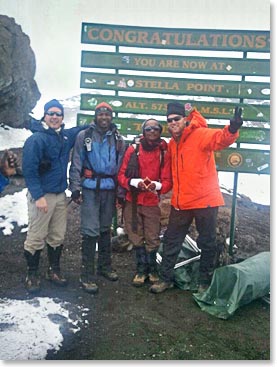 Danny and Hendrik with their guides Emmanuel and Samson on the top of Kilimanjaro -19340ft. Great job team!