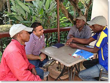 Bharath and his guides, Fredy and Kornel, go over the details of his climb.