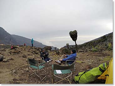 Doug and Bharath resting at camp