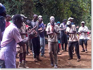 A very happy staff meets the team with song and dance!