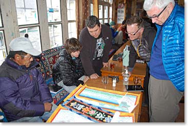 Ang Pasang Sherpa lost his fingers to frostbite on a climbing expedition. He now paints beautiful Thangka paintings that depict Sherpa life in the Khumbu.