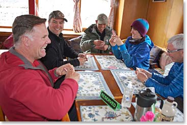 The team enjoys a game of cards and wonderful company in their lodge in Pheriche