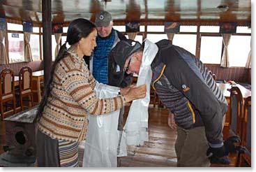 Jim Brown receives his blessing scarf from Temba’s wife.