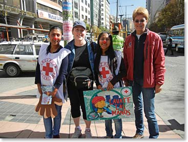 The girls with two volunteers from Cruz Roja Boliviana (Bolivian Red Cross). These girls are spreading awareness to young children about the importance of washing their hands to stop the spread of germs and diseases.