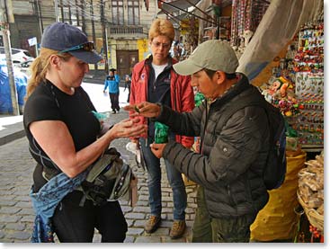 Micheline buying some cocoa leaves. Chewing on these leaves is said to help with acclimatization