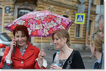 Lina and Johanna share an umbrella as it began to rain this afternoon.
