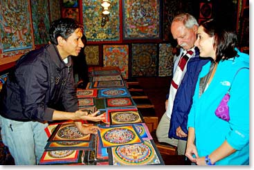 Inspecting thanka paintings at Boudhanath