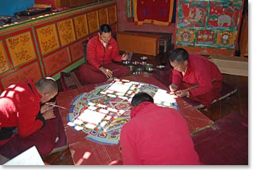 Monks working on sand Mandala painiting