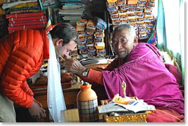 Travis has his sumje, a blessing cord tied round his neck by the Lama.