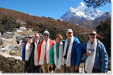 The team wearing their white Khata blessing scarves outside Lama Geshi’s house,  Ama Dablam is beautiful.