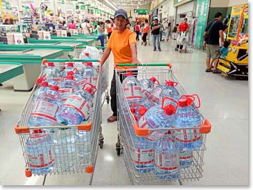 Maria shops for the important expedition items. Here she is with two weeks of water!