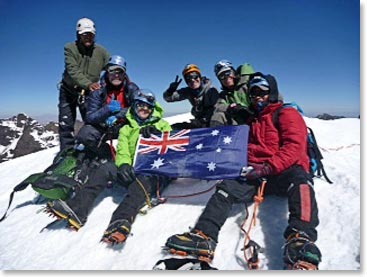 Margaret holds her country’s flag high on the mountain