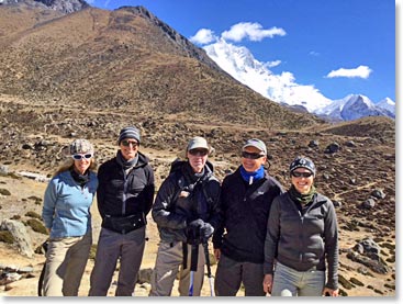Here the team stands with Lhotse, the 4th highest mountain in the world on the left and Island Peak on the right with its triangular rock face.