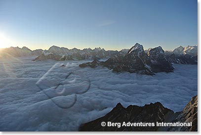A magnificent sunset from Camp III, with Towouche and Cholatse Peaks across the clouds.