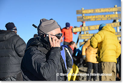 Frank Giustra making a call from the summit