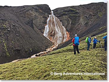 Team hiking with Iceland lava and water