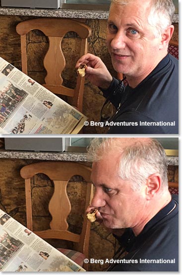 Steven Cummings pretending that he can read Icelandic newspaper and eating a Kleina, an Icelandic pastry.