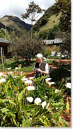 Linda taking a picture of flowers by the hot springs