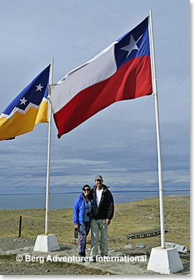 Staci Wendt and Cole Standish at water’s edge with the Punta Arenas and Chilean National Flags