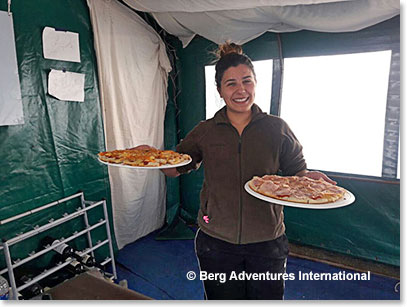 Julieta serving pizzas to hungry climbers!