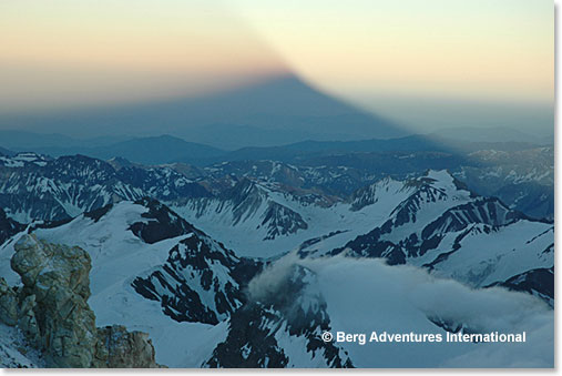 After climbing high above Berlin Camp, the shadow of Aconcagua becomes visible as the sun rises.
