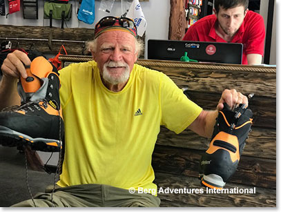 Woodie trying on rental boots at rental shop in Azau