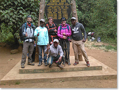 Josh, Adriana and Andrea with BAI Mountain guides Cornel, Cyprian and Erick at the Lemosho Gate