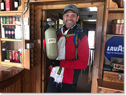 Scott Walker admiring oxygen bottle from an Everest Expedition 1953